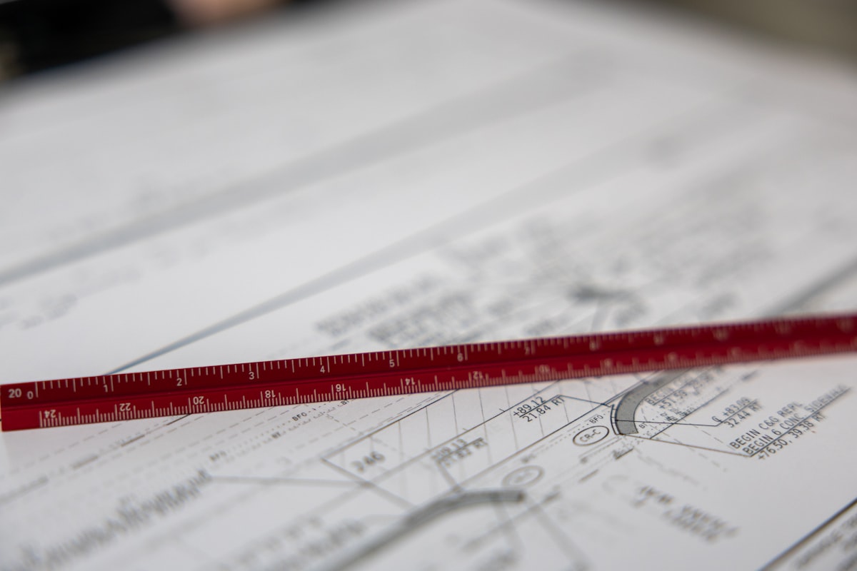A ruler measuring a landscaping plan by hand